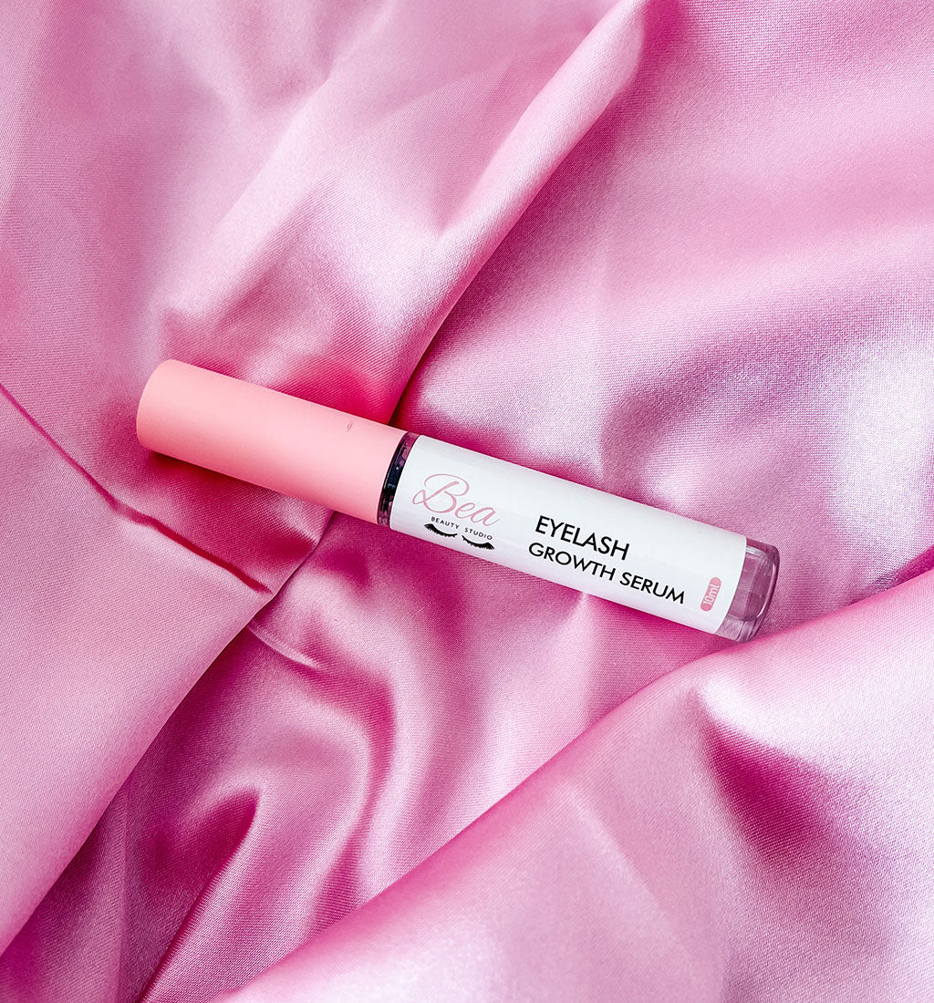 Bea Beauty Studio's Eyelash growth Serum on a satin background.