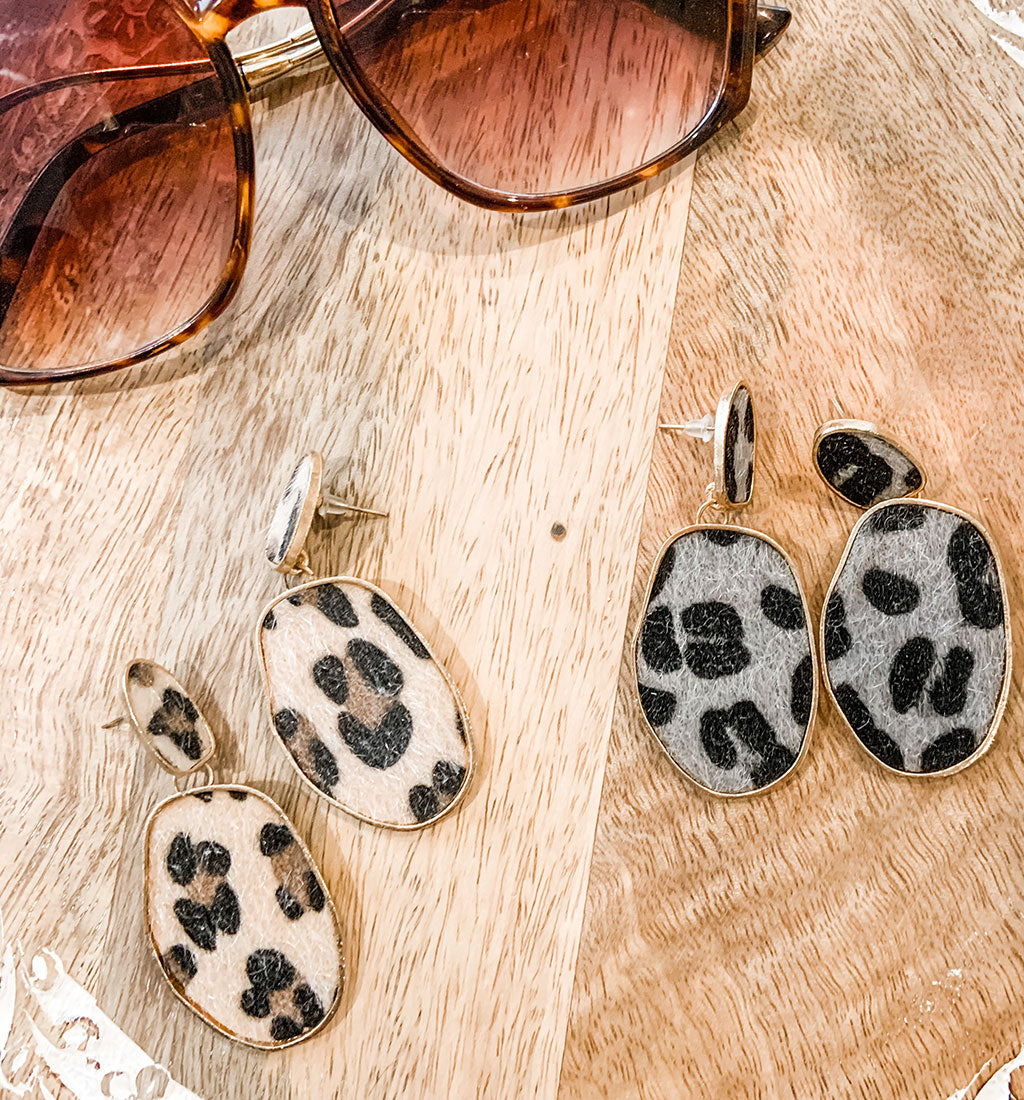Cheetah print earrings in traditional tan and black and grey and black with gold hardware. 